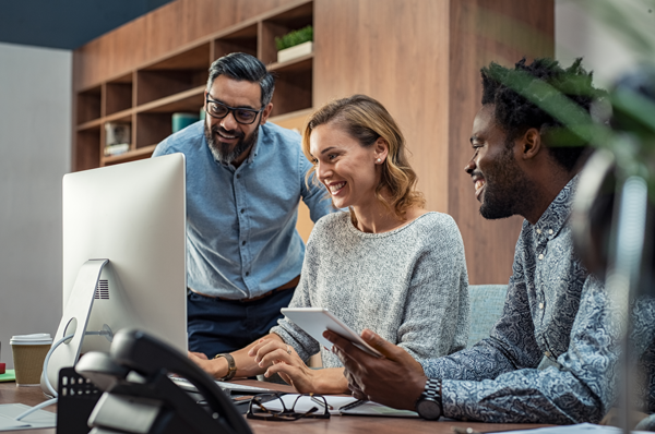 Three SEO copywriters researching work on computer