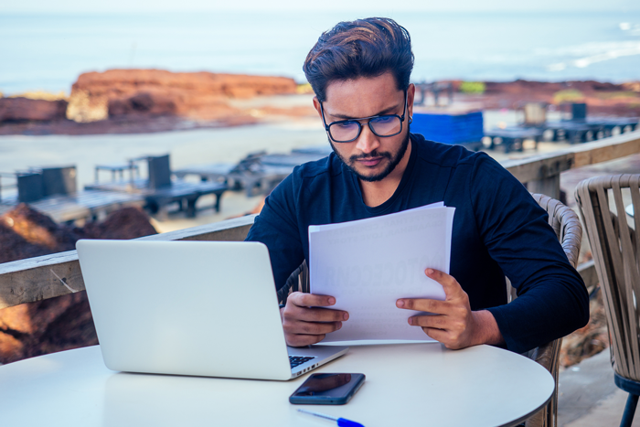 Copywriter working at a laptop computer outside