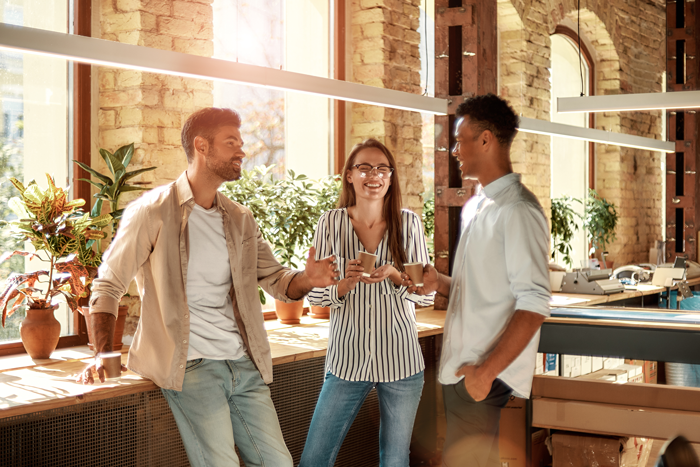 Group of three copywriters standing talking