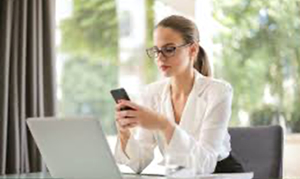 Business woman on a smartphone at desk