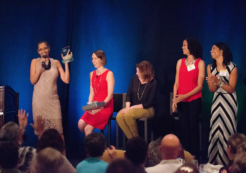 Carline on stage receiving the 2015 AWAI Copywriter of the Year Award