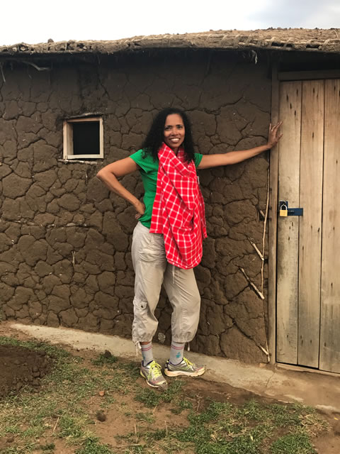 Carline living with Masai Mara tribesmen in a dung home in Kenya