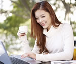 Woman Working on Computer in Coffee Shop