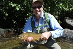 Ed estlow holding a big fish he caught in a river