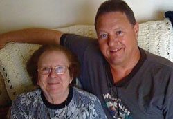 John Torre sitting on a couch with his mother