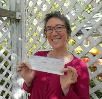 Shannon Goheen holding a check