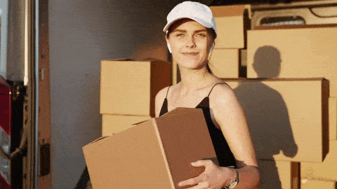 A woman holding a cardboard box