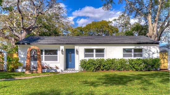 A white house with a green yard